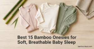 best bamboo onesies: three folded baby onesies (silky sleeper, long-sleeve bodysuit, footed pajama) on light wood with bamboo stalks and leaf